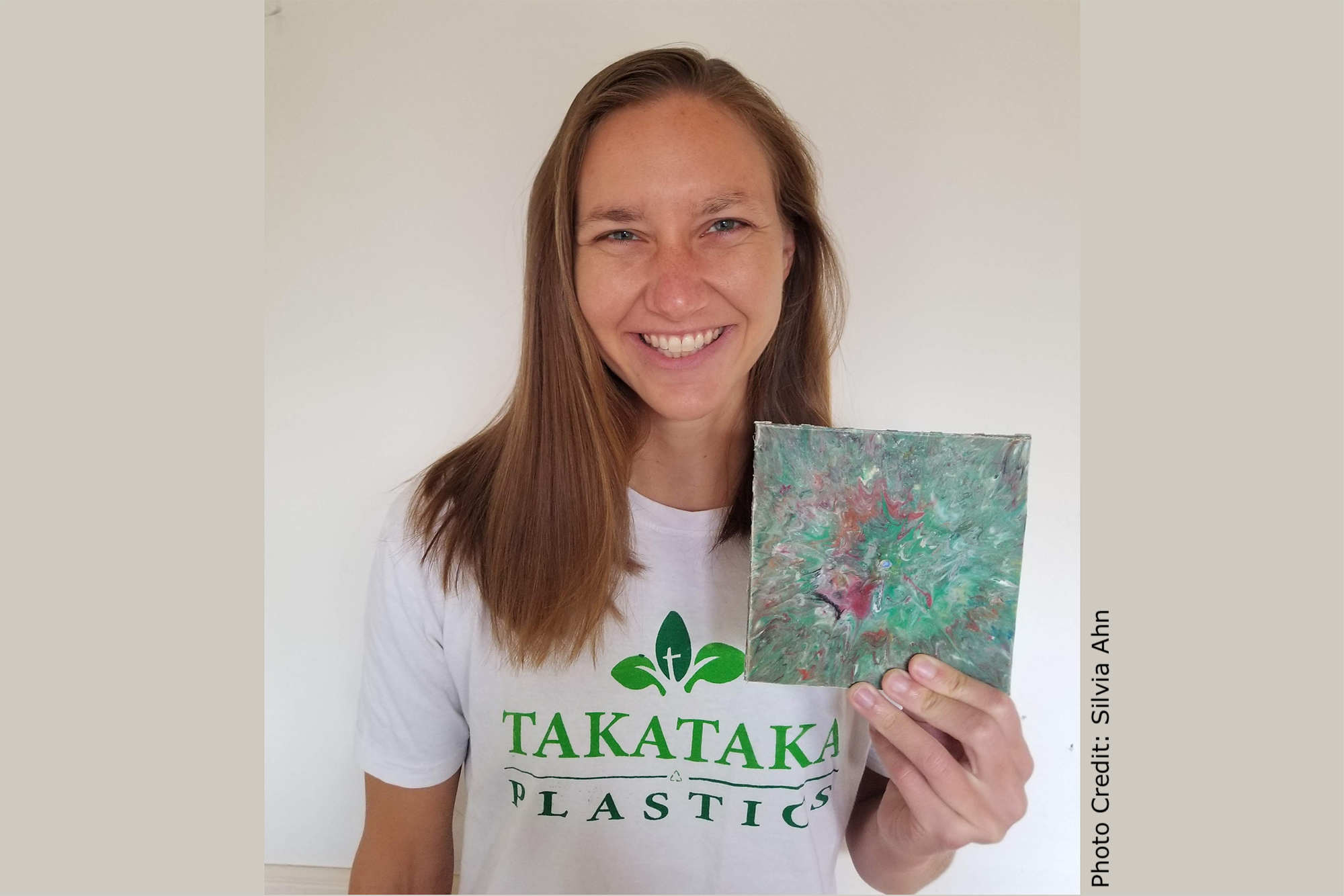 Paige Balcom of University of California, Berkeley with a wall tile made from her machines that convert PET plastic into useable, salable items.