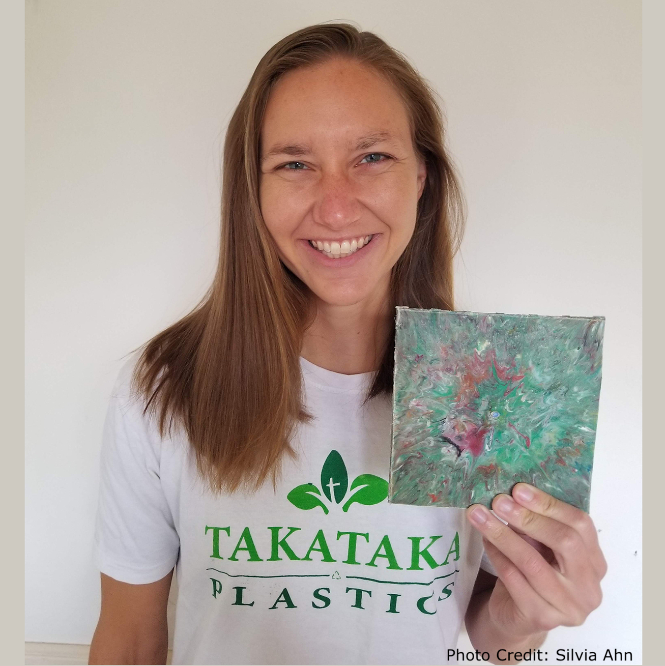 Paige Balcom of University of California, Berkeley with a wall tile made from her machines that convert PET plastic into useable, salable items.