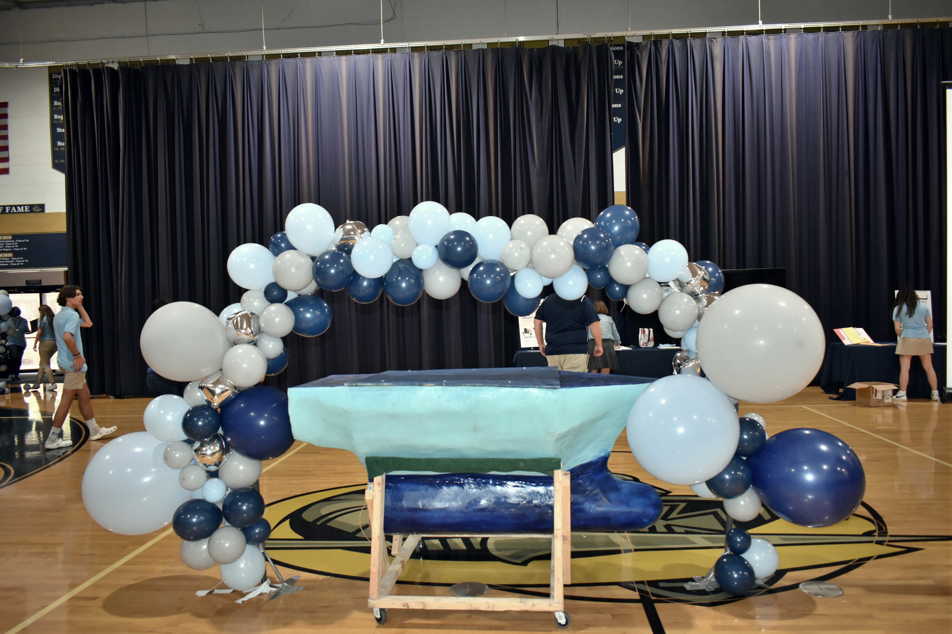 An autonomous marine rover is displayed surrounded by balloons.