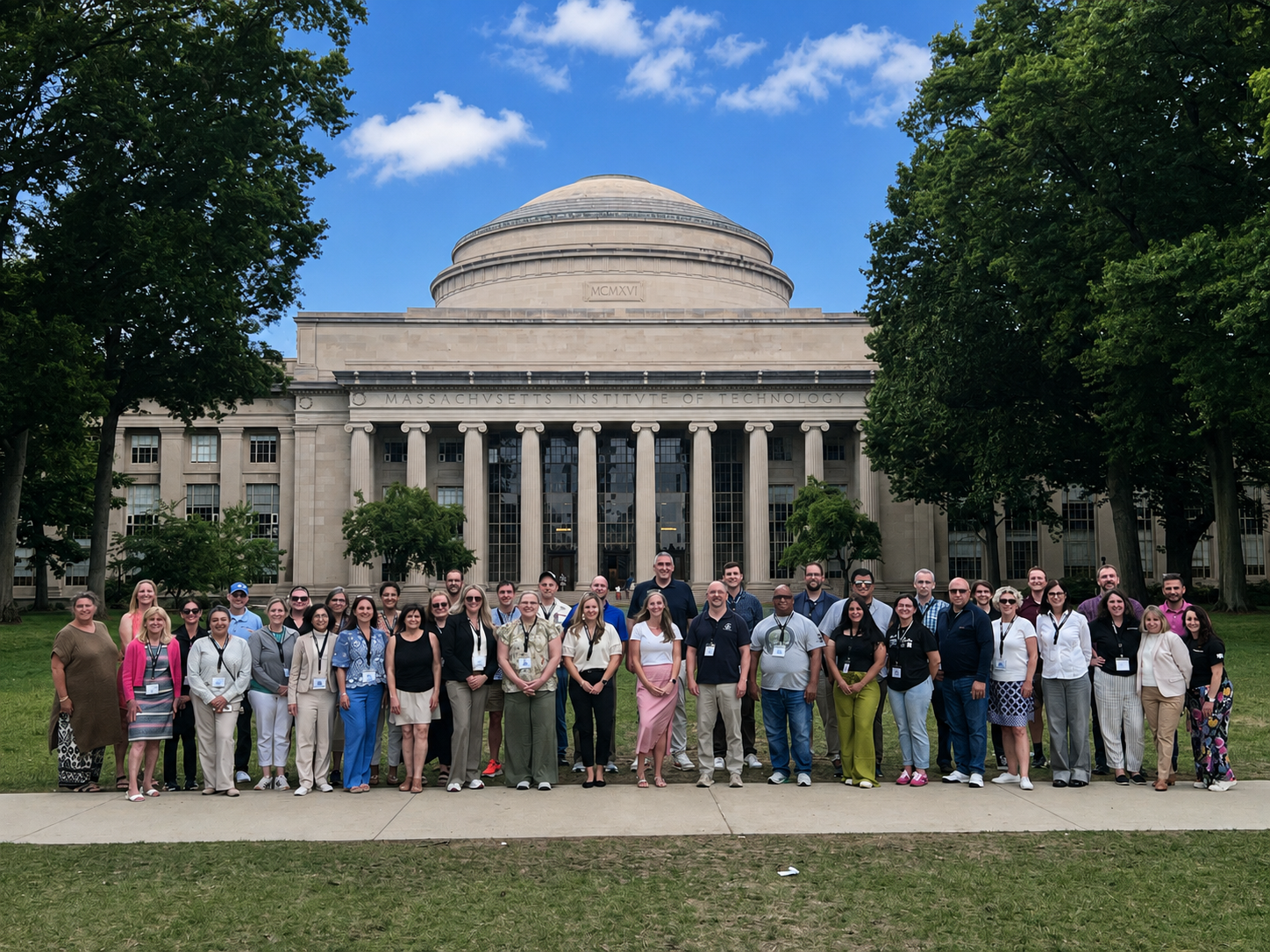 Educational leaders from across the country pose for a picture on Killian Court.