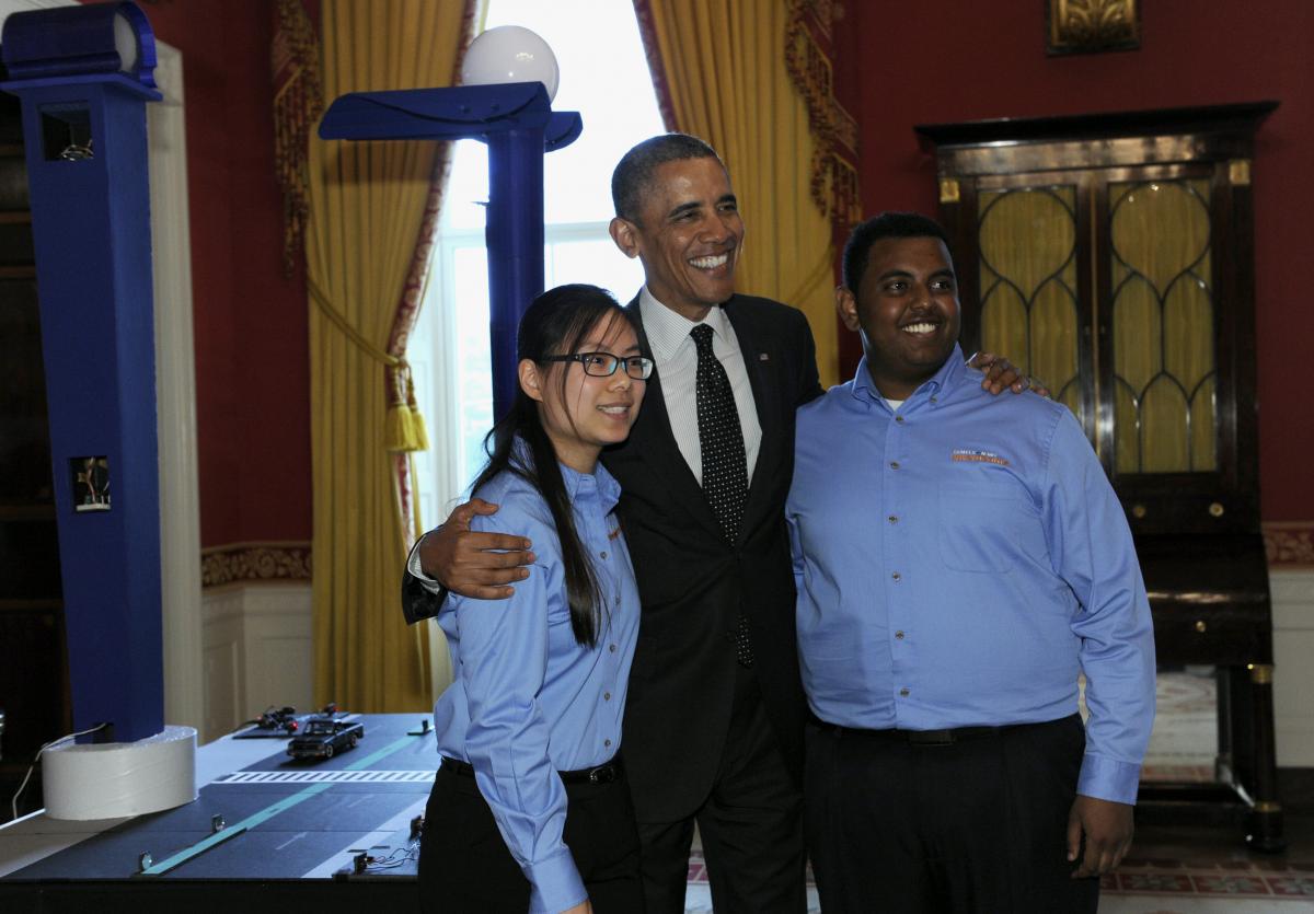 President Obama poses for a photo with Karen Fan and Felege Gebru
