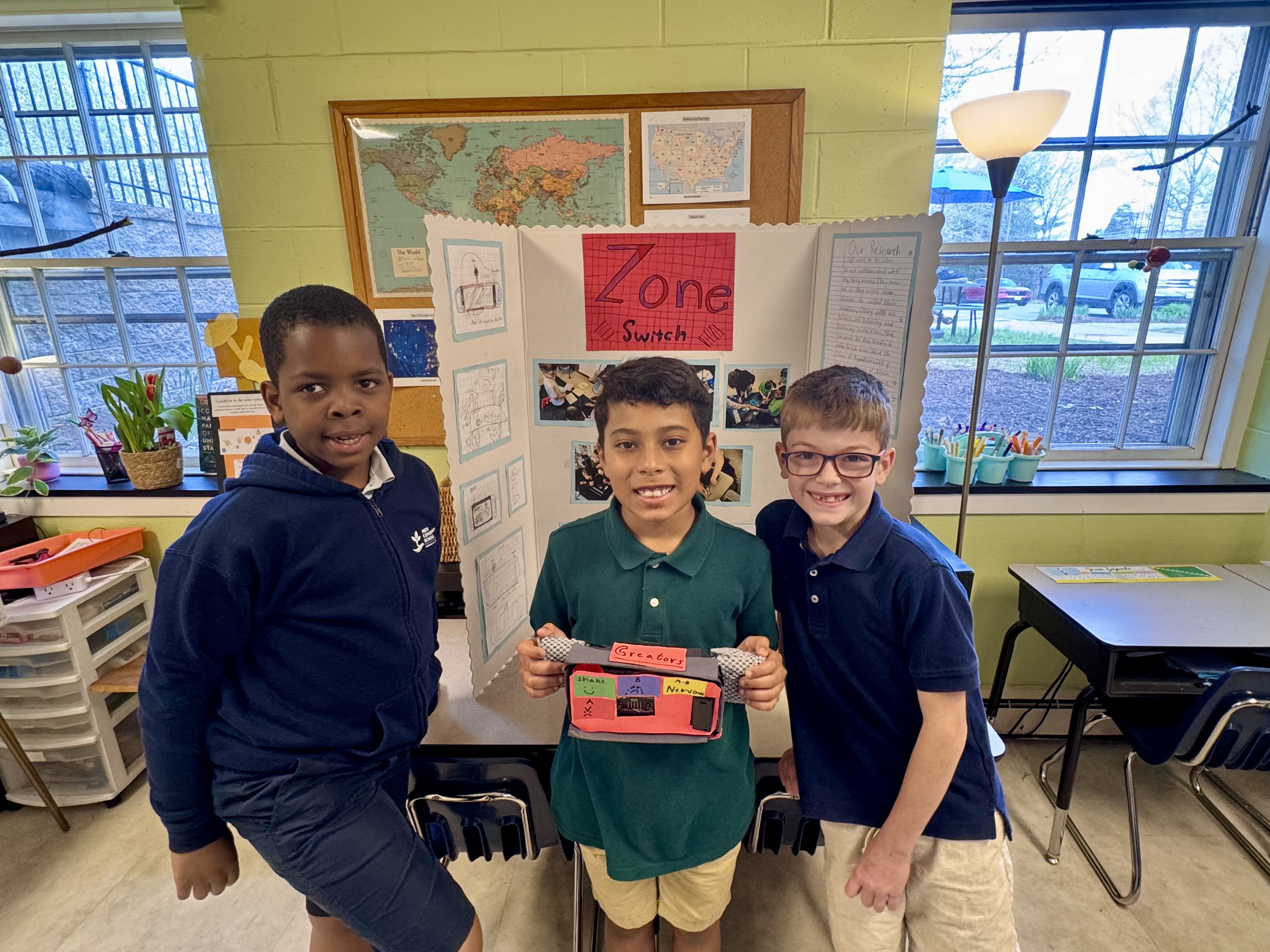 Three boys present their invention