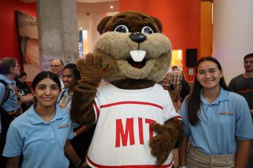 Two teens pose with Tim the Beaver at EurekaFest