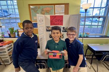 Three boys present their invention