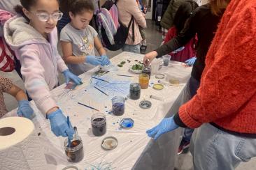 two girls dyeing the cotton bags