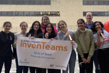 Girls of Steel Team with banner